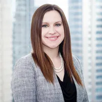 A woman in a gray jacket and black shirt