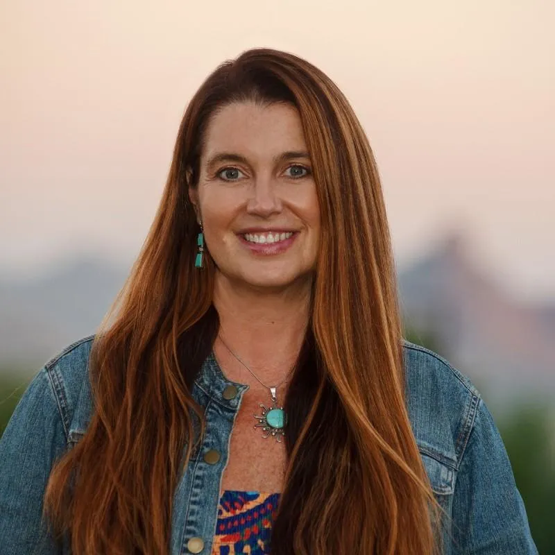 A woman with long hair and a blue shirt.